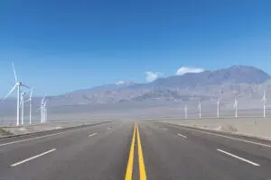 Landscape with road and wind turbines alongside