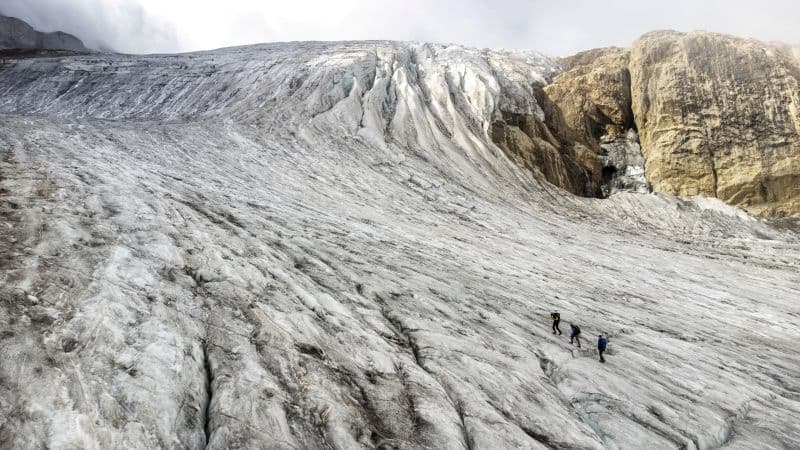 FILE PHOTO: Glaciologist Matthias Huss together with members of the Glacier Monitoring in Switzerland (GLAMOS) Romain Hugonnet and Andreas Linsbauer climb the Gries glacier during a trip to check measuring equipment in Gries, Switzerland, September 2, 2022. REUTERS/Denis Balibouse/File Photo