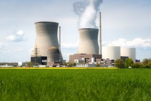Nuclear power plant with yellow field and big blue clouds