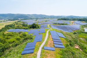 Solar power plant on hillside, aerial view of clean energy in mountainous area